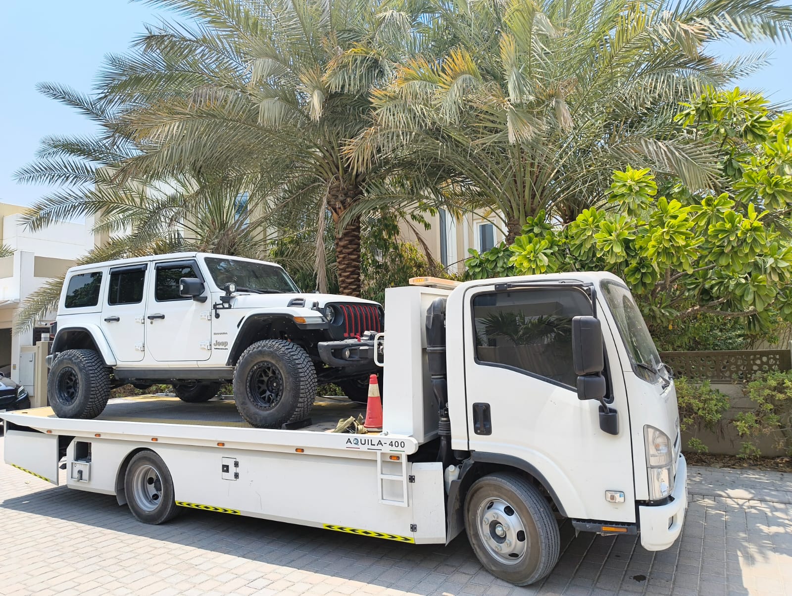 Safely Truck Recovery flatbed transporting a Jeep in the UAE